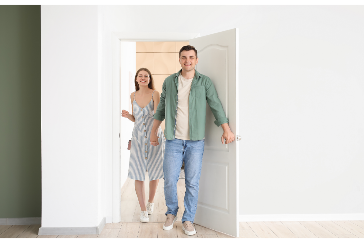 Couple Opening Door to Home
